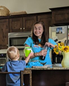 Woman smiling at her son in the kitchen.