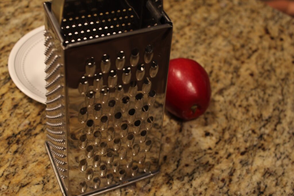 Grater and an apple