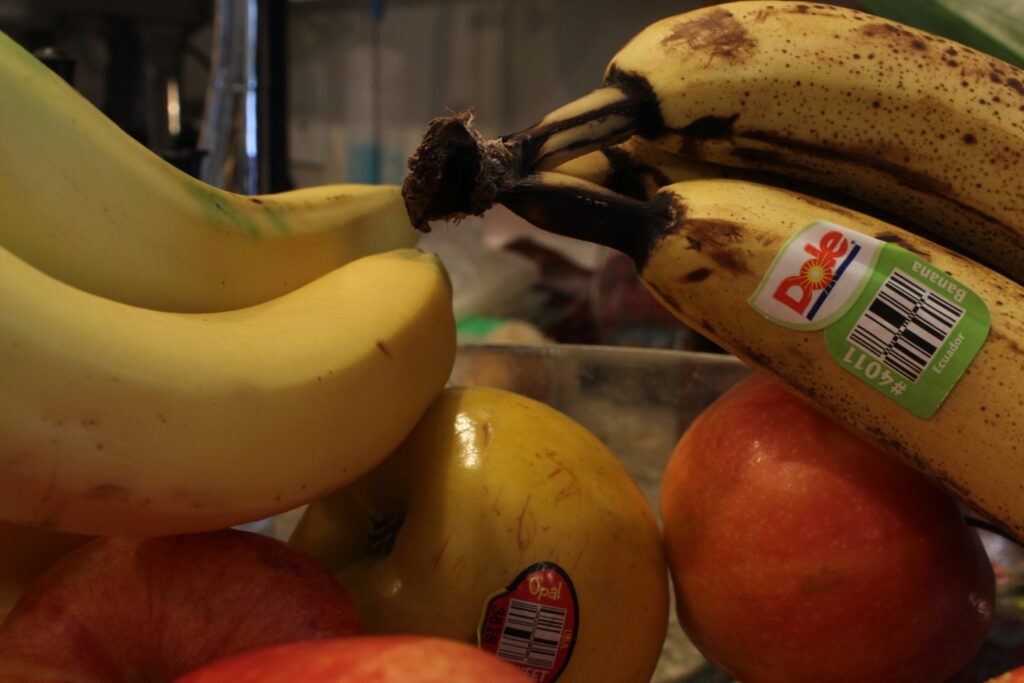 close up of fruit bowl with apples and bananas.