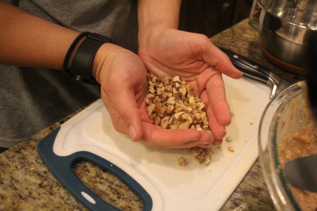 hands full of chopped walnuts.