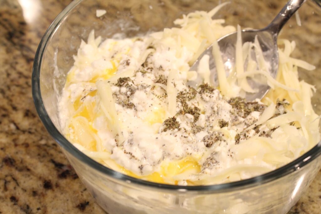 Mixing the cottage cheese layer for a veggie lovers lasagna.