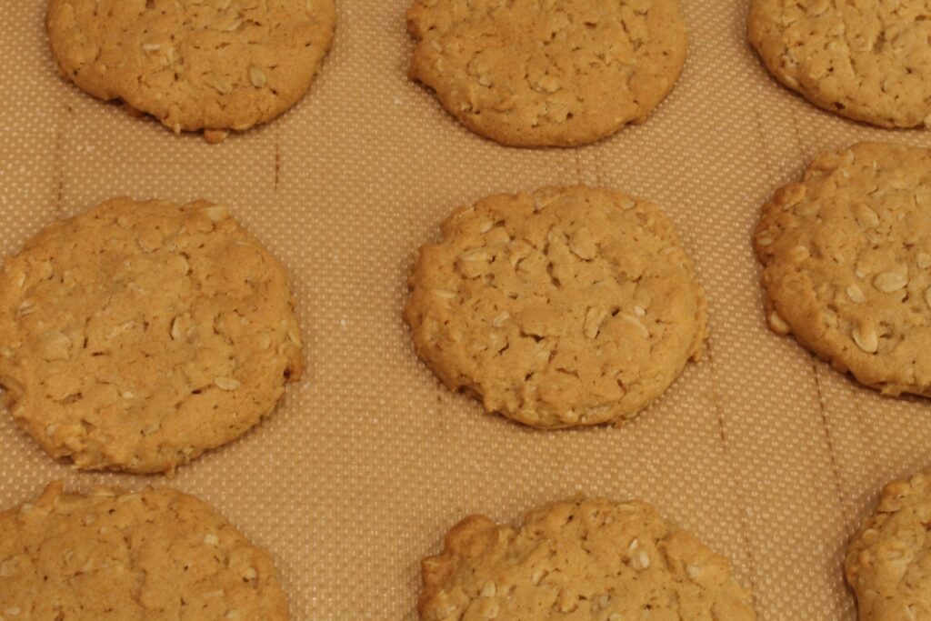 Natural peanut butter oatmeal cookies on a baking sheet.