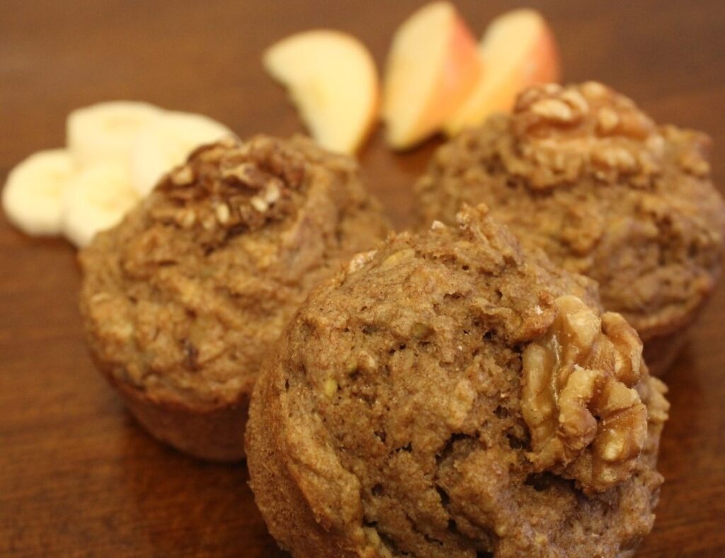 Whole wheat apple banana muffins with walnuts on top.