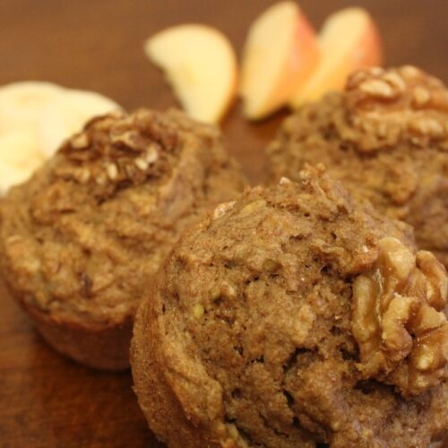 Whole wheat apple banana muffins with walnuts on top.