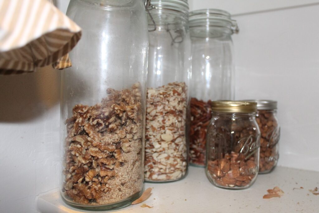 Jars of nuts in a pantry.