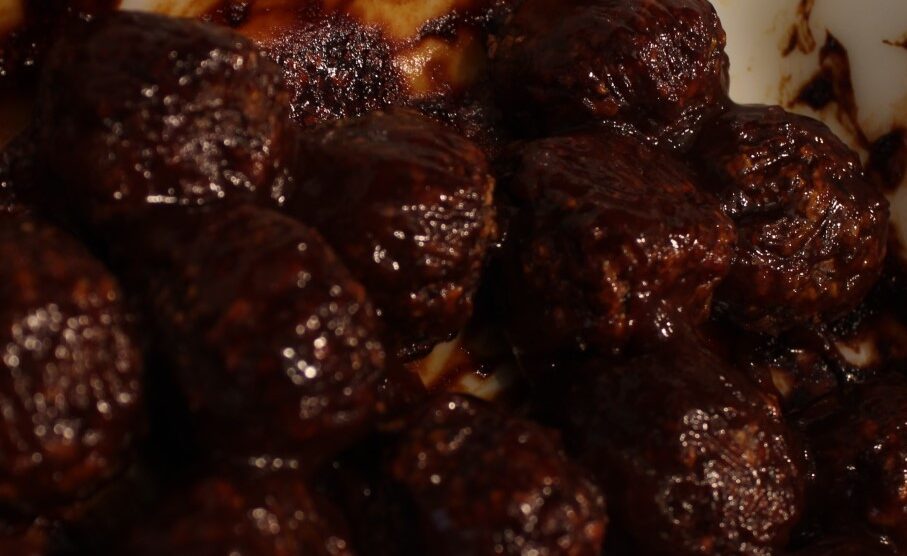 Mushroom meatballs covered in BBQ sauce.