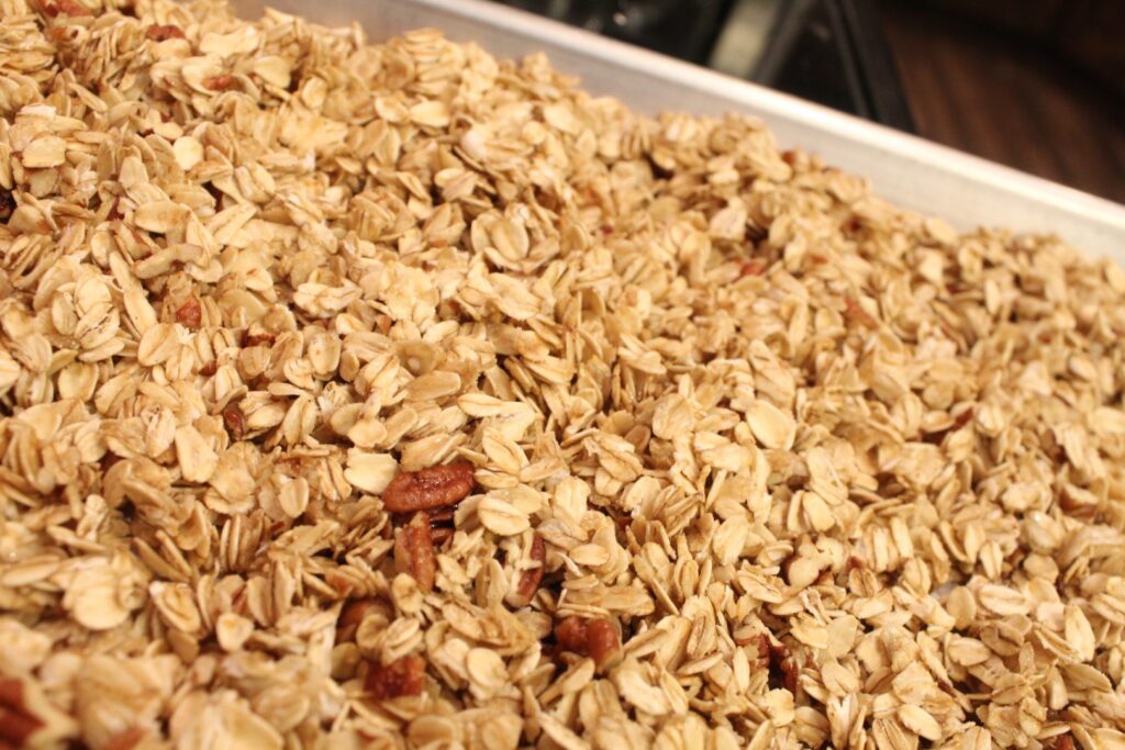 Easy 15 minute granola spread out on a baking sheet.