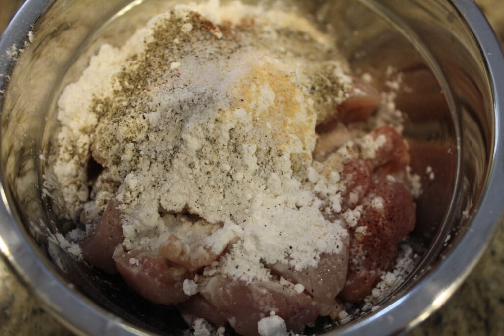 Diced chicken covered in cornstarch and seasonings.