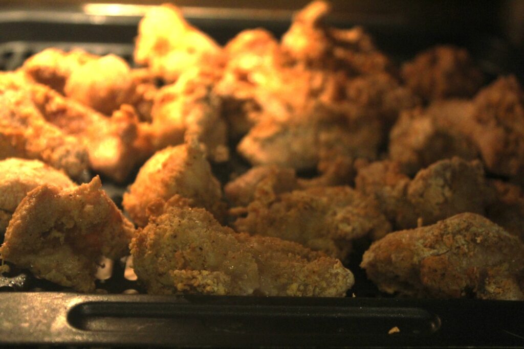 Cooked breaded chicken in an air-fryer.