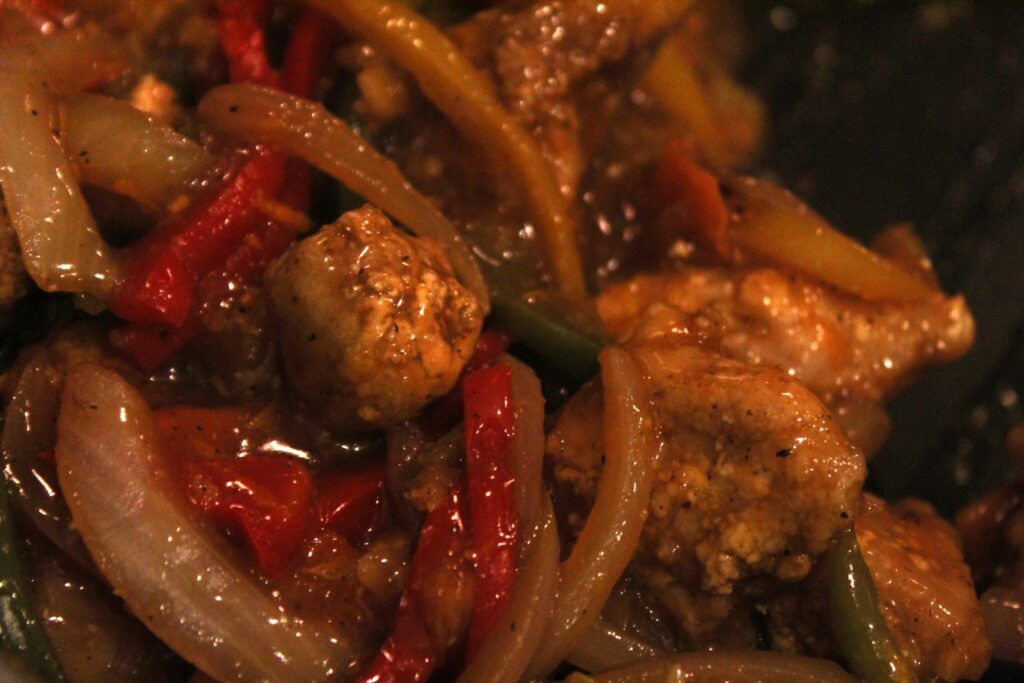 Mess free air fryer orange chicken with peppers, onions, and carrots.