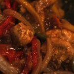 Mess free air fryer orange chicken with peppers, onions, and carrots.