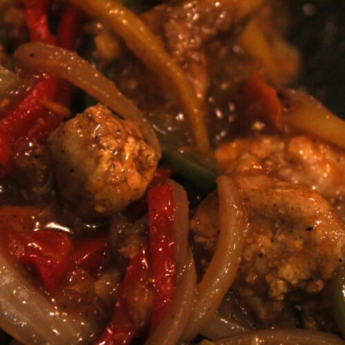 Mess free air fryer orange chicken with peppers, onions, and carrots.