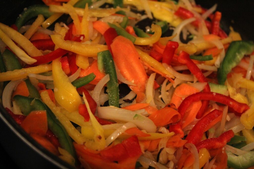 Vegetables for air-fryer orange chicken sauce sauteing in a frying pan.