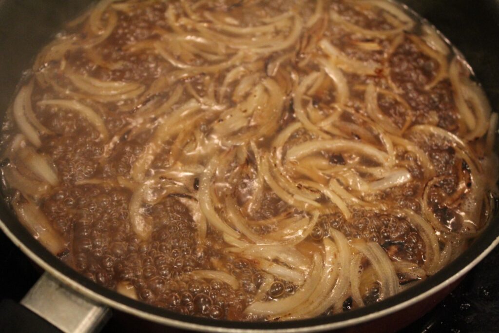 onion slivers boiling in broth.