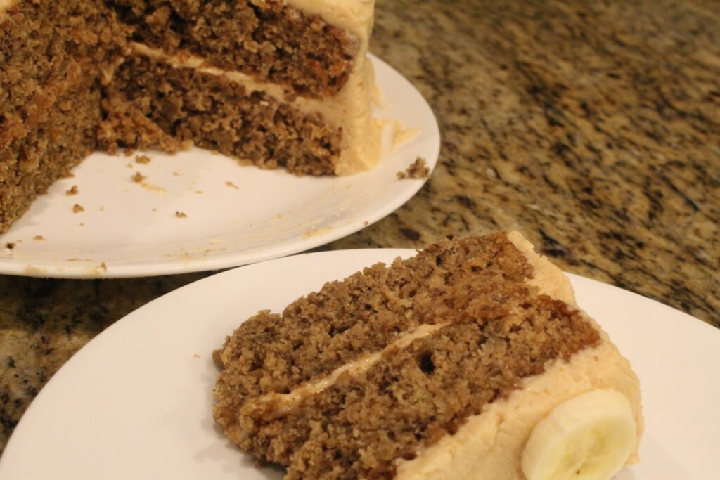 Slice of banana oat cake with peanut butter frosting.