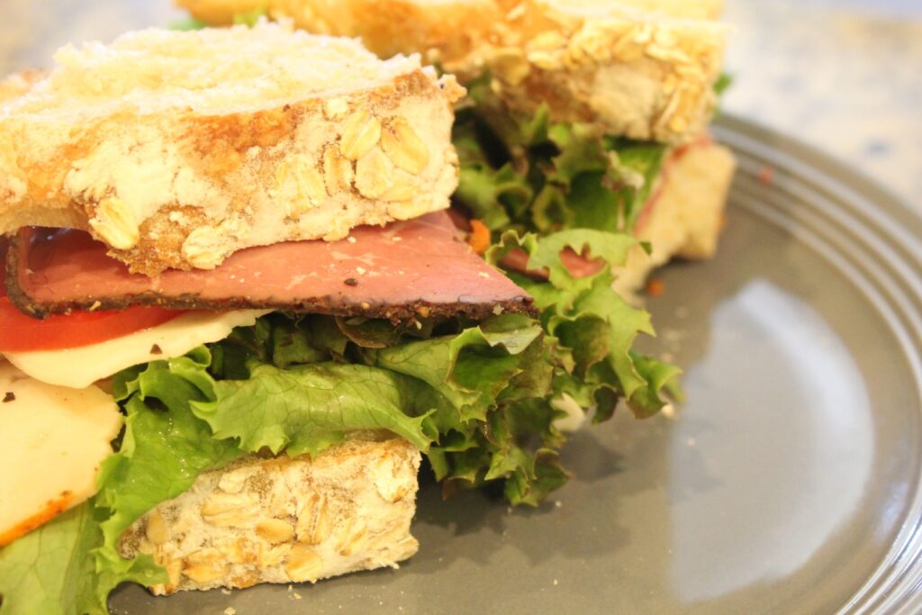 A sandwich made from sourdough honey oat bread. 