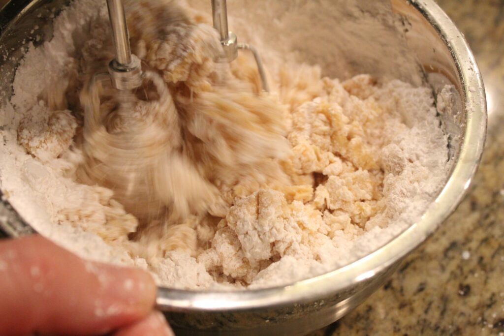 Mixing powdered sugar into frosting.