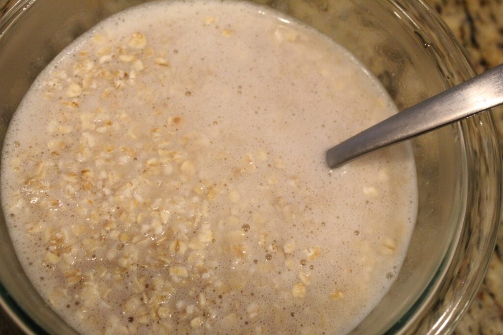 Oats soaking in a bowl of water