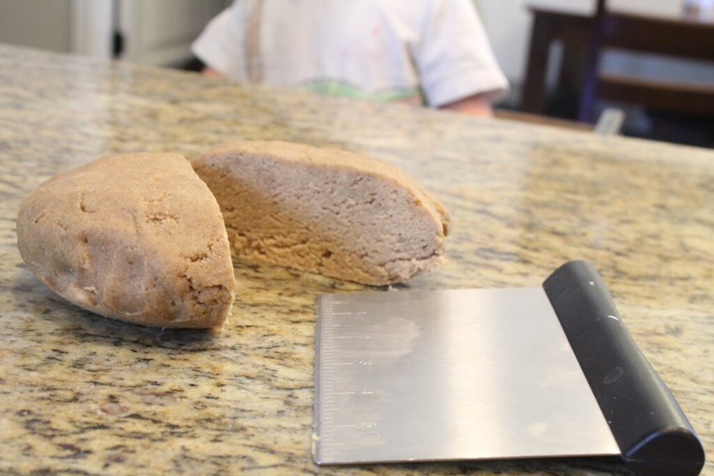 Sourdough graham cracker dough cut in half.