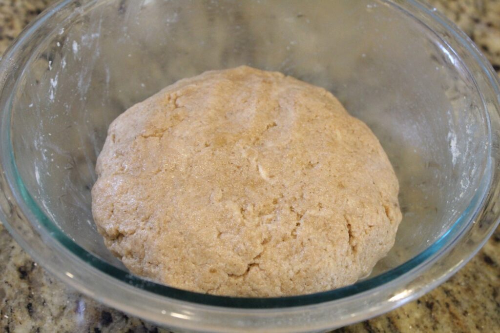 Sourdough graham cracker dough shaped into a ball.