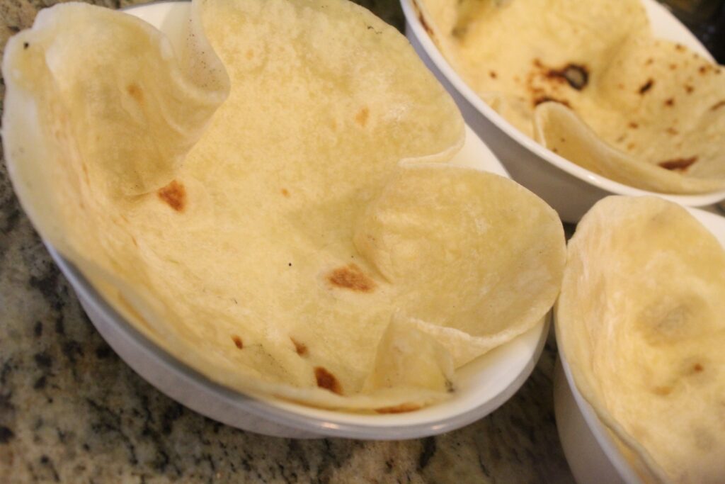 Tortillas shaped into glass bowls.