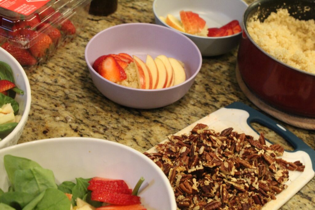 A spread of ingredients for strawberry spinach salad. 