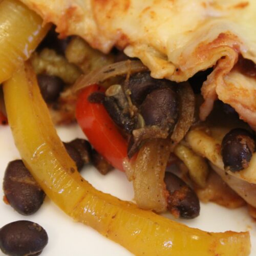 close up picture of a black bean fajita enchilada.