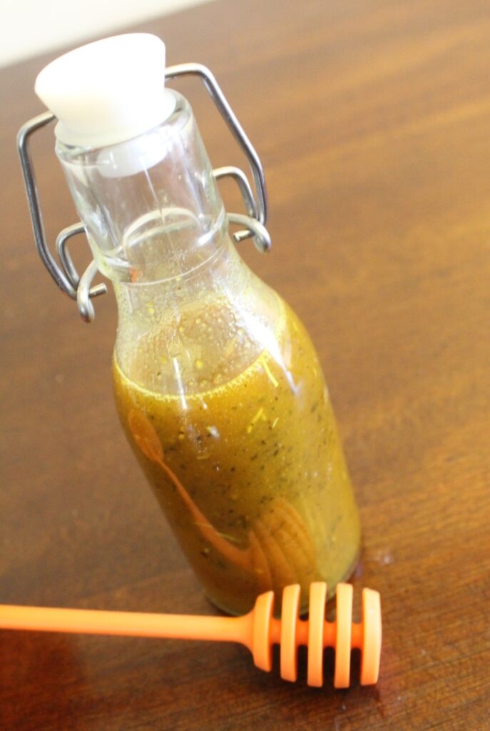 Small jar of honey mustard vinaigrette.