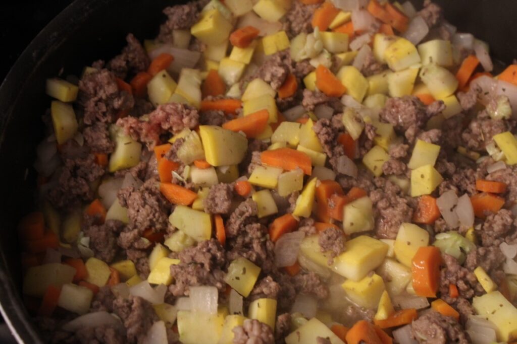 Ground beef and vegetables cooking in a pan. 