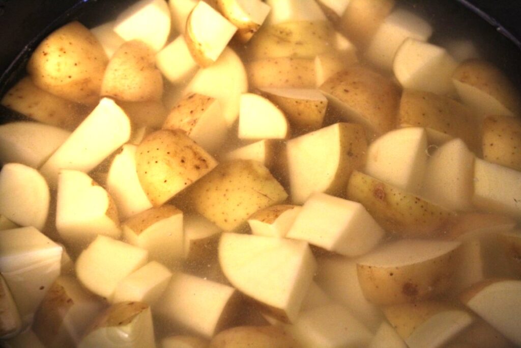 Potatoes in a pot covered with water. 