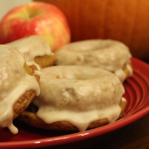 Plated pumpkin applesauce muffins with apple sauce glaze.