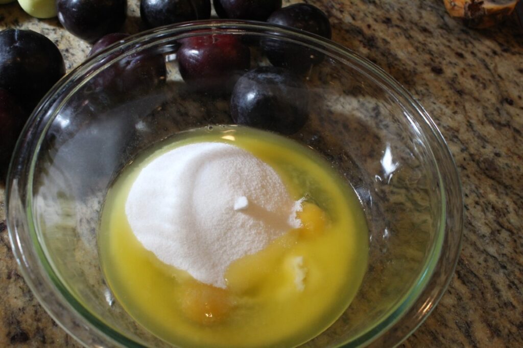 Eggs, sugar, and melted butter in a mixing bowl.