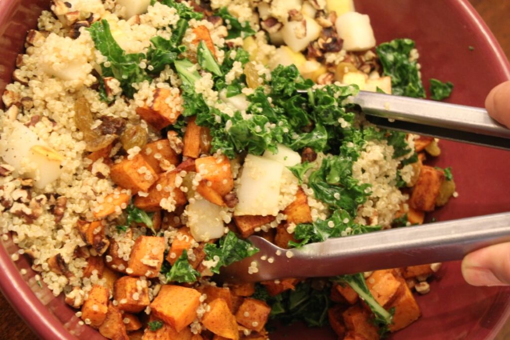 Tossing the fall Kale salad with pear and sweet potato.