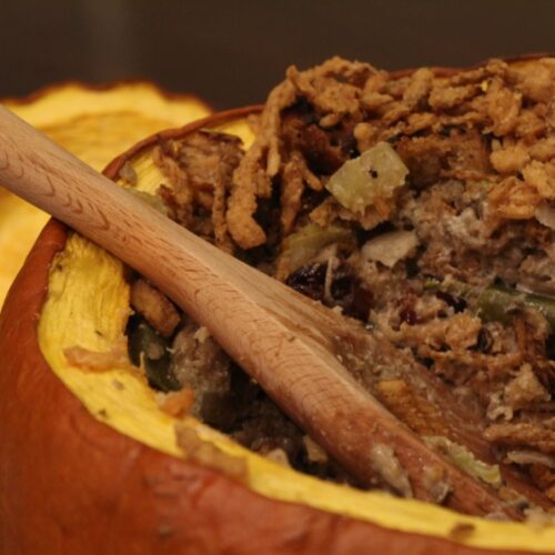 thanksgiving stuffing casserole served from a pumpkin.