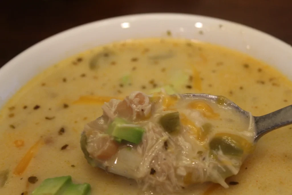 a spoonful of white chicken chili over a bowl.