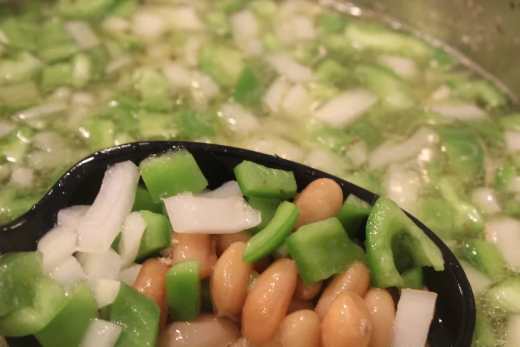 beans, peppers, and onions in broth.