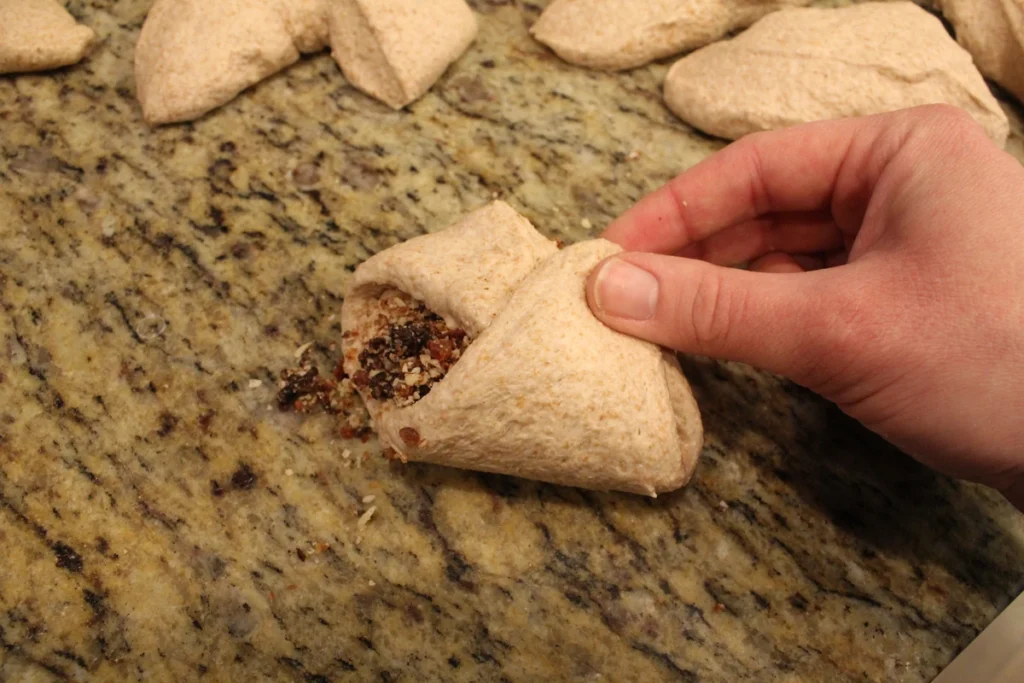 folding filling into a piece of sourdough naan dough.