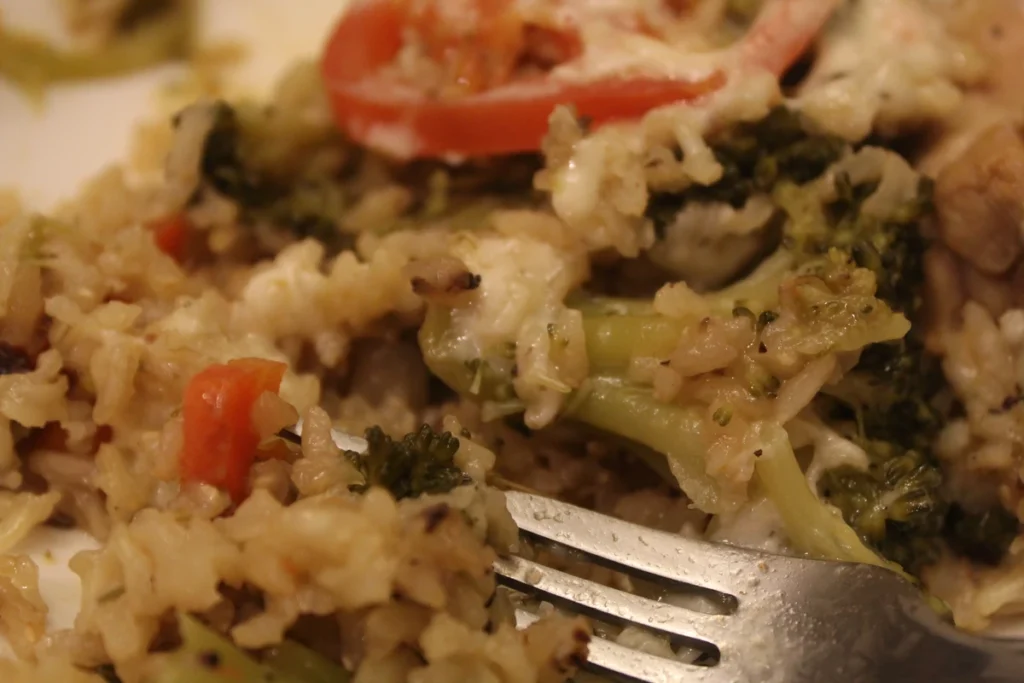 scooping a bite of one pot brown rice with a fork.