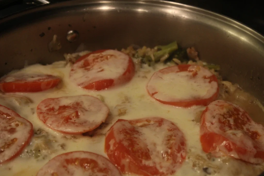 One pot Brown rice topped with Tomatoes and cheese.