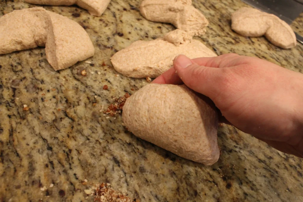 rolling filling into sourdough naan dough.