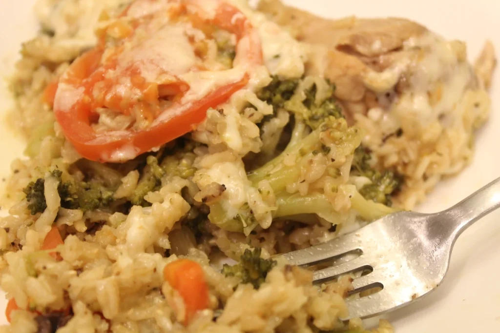 Serving of one pot rice topped with tomatoes and cheese.