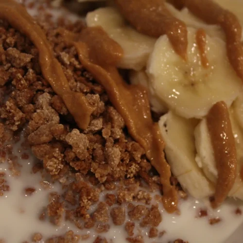 Grape nuts topped with banana, peanut butter, and milk.