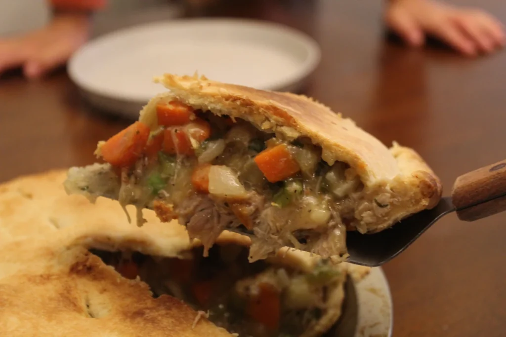 Serving a slice of chicken pot pie.