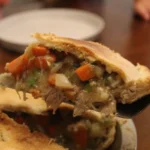 Serving a slice of chicken pot pie.