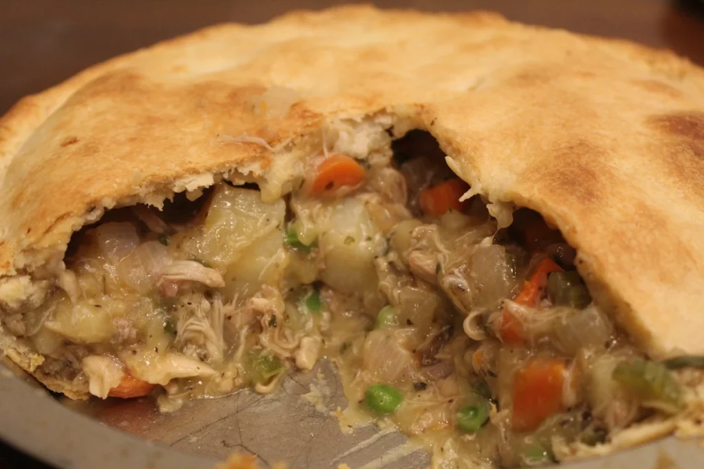 Chicken pot Pie with 1/4 of the pie already eaten.