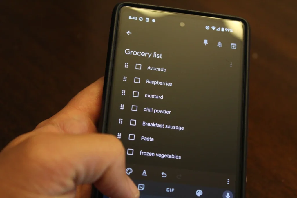 Typing out a grocery list on a phone.