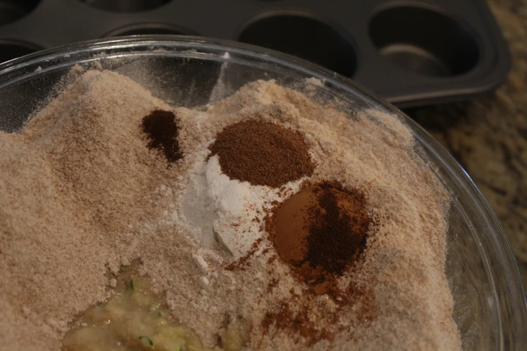 Whole wheat flour with baking powder and spices in a bowl.