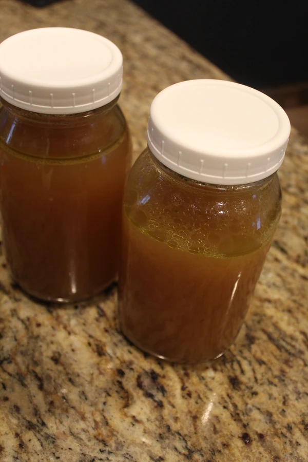 glass jars full of home made bone broth. 