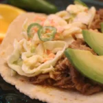 lime slaw on top of citrus taco.