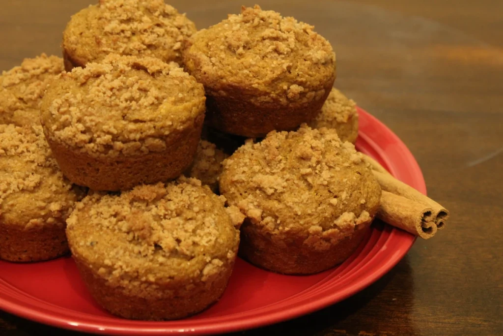 Plate stacked with pumpkin applesauce muffins.